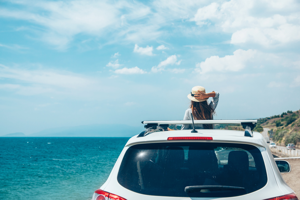 Summer car maintenance in Orlando, FL, by Griffis Automotive Repair. Image of a car parked by the ocean, showcasing the importance of ensuring your vehicle is in top condition for summer drives.