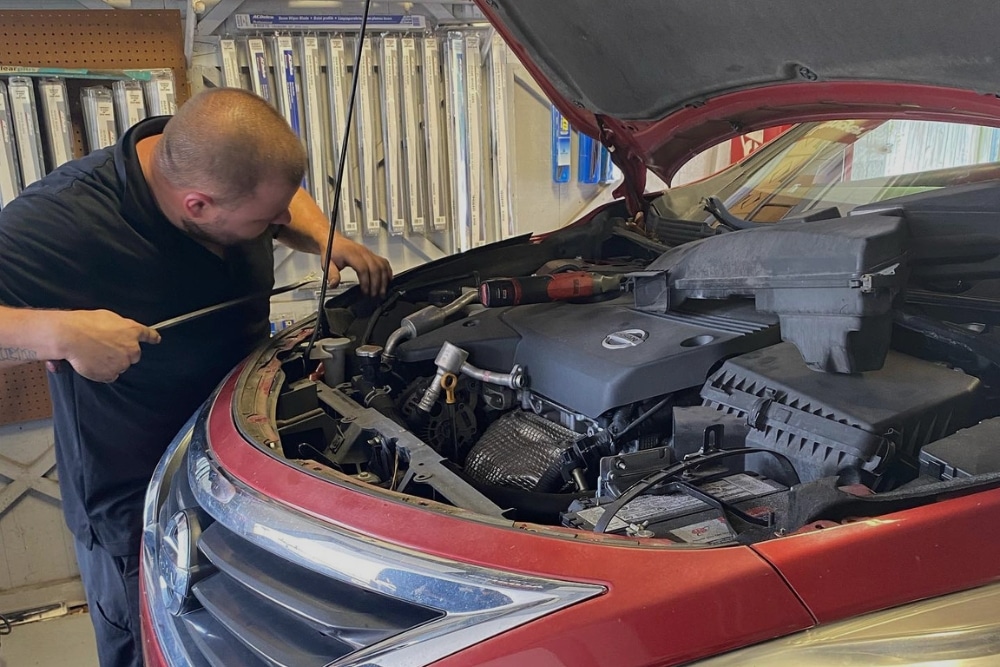 Auto Repair, Auto Mechanic In Orlando, FL At Griffis Automotive Repair. Mechanic checking vehicle engine at auto repair shop in Orlando, FL