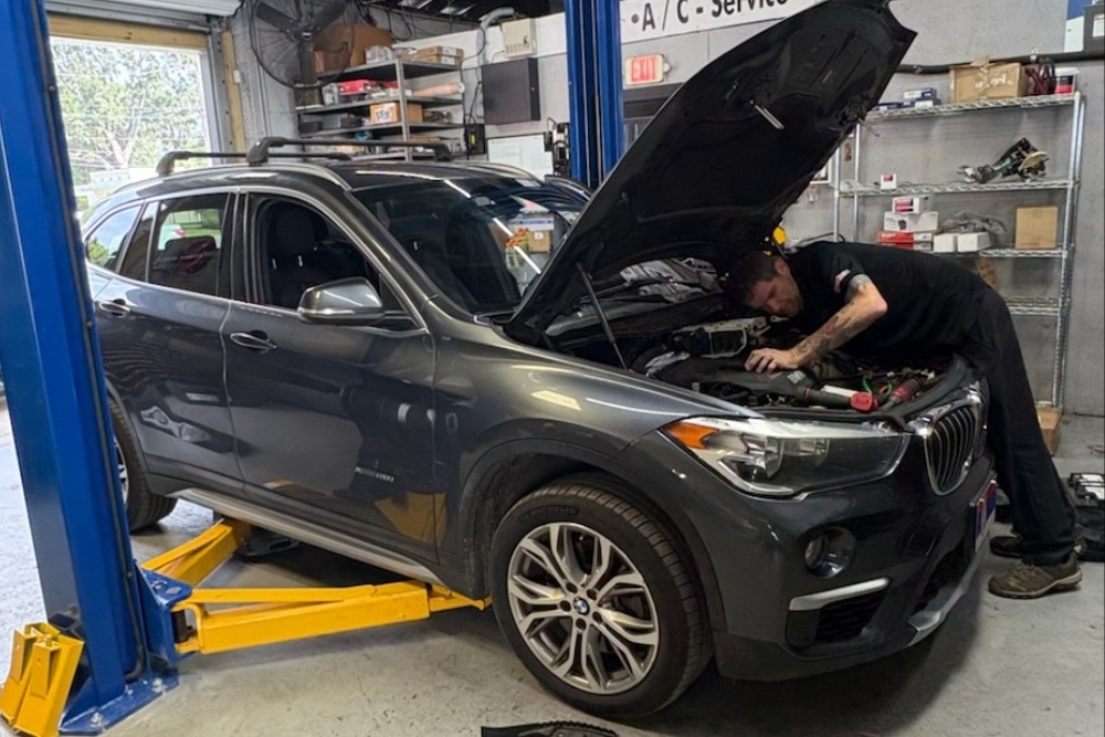 Seasonal Preventative Maintenance In Orlando FL At Griffis Automotive Repair. Mechanic inspecting a vehicle engine for seasonal maintenance