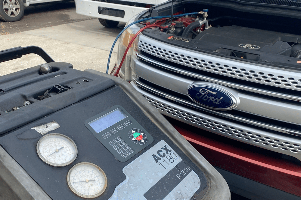Auto A/C Repair in Orlando FL at Griffis Automotive Repair. An automotive AC recharge machine services a car's air conditioning system to diagnose and fix poor cooling performance during hot summer weather.